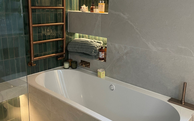 Wet Room With A Straight Panel Bath And A Copper Colour Tower Radiator